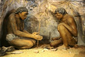 Ancient humans starting a fire.